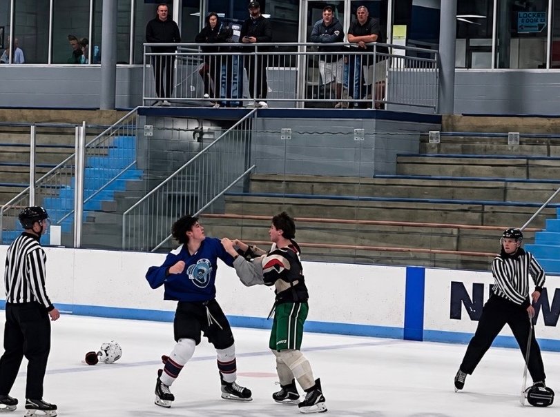 Burke Crowell standing up to an older player at the NAHL main camp